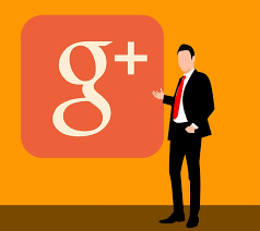 This is an image of a man in a suit standing by the Google plus logo.